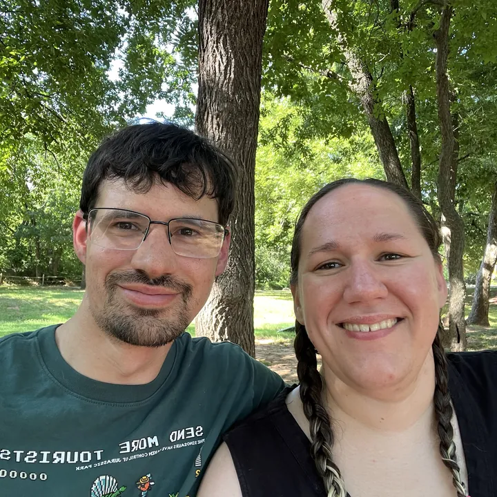 Keith and Emily under the trees at a park